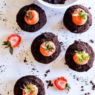 Chocolate cupcakes with whipped chocolate ganache dipped in Oreo crumbs and topped with a candy coated strawberry (that looks like a carrot!). These dirt cupcakes are perfect for springtime!