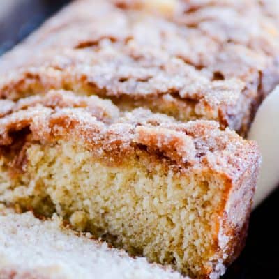Deliciously moist banana bread with a cinnamon swirl in the middle and a crispy cinnamon sugar coating on the outside.