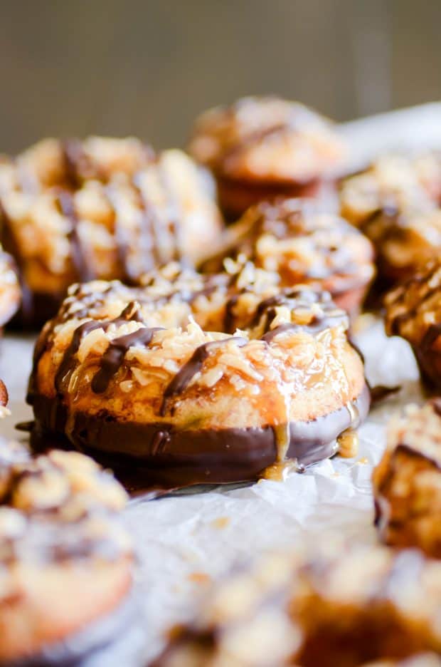 These moist banana bread donuts are baked to perfection, dipped in chocolate, and smothered with coconut and caramel. The banana bread reincarnation of Samoas.