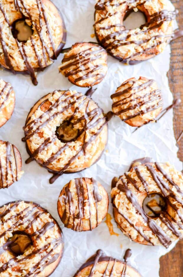 These moist banana bread donuts are baked to perfection, dipped in chocolate, and smothered with coconut and caramel. The banana bread reincarnation of Samoas.