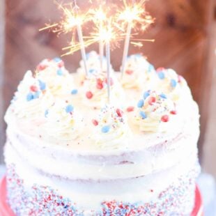 Fun and festive red (and blue) velvet layers of cake complete with cream cheese frosting and a fun surprise candy filling!