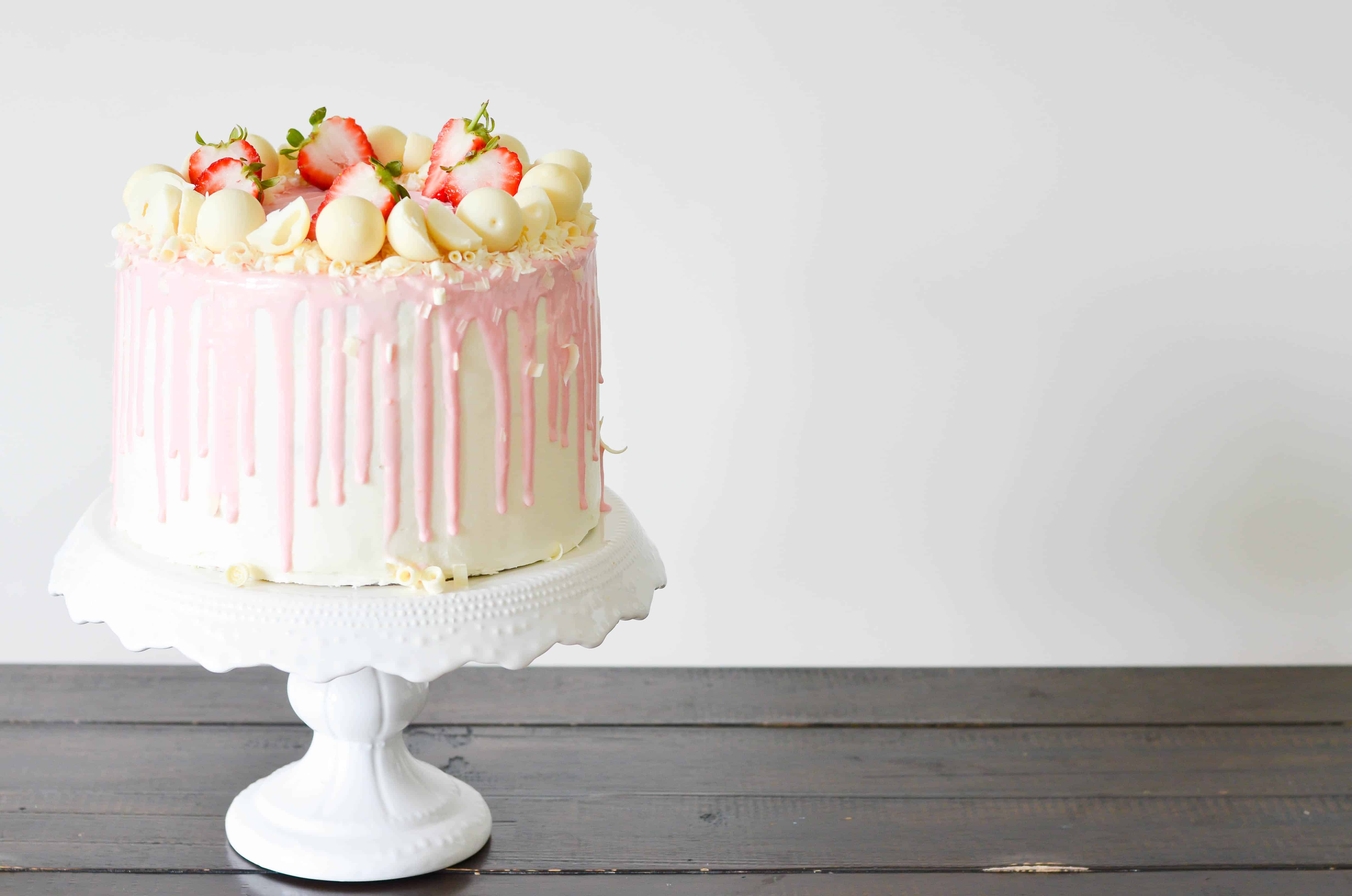 Fluffy white cake made from scratch, filled with my mom's homemade strawberry sauce, and frosted with a whipped white chocolate buttercream that is TO DIE FOR. 
